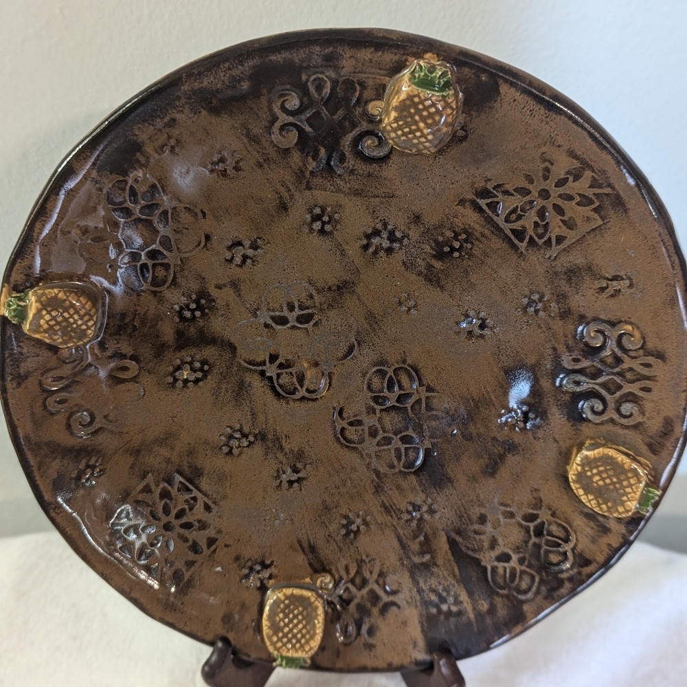 Decorative Handmade Pottery Plate with Pineapple Accents.